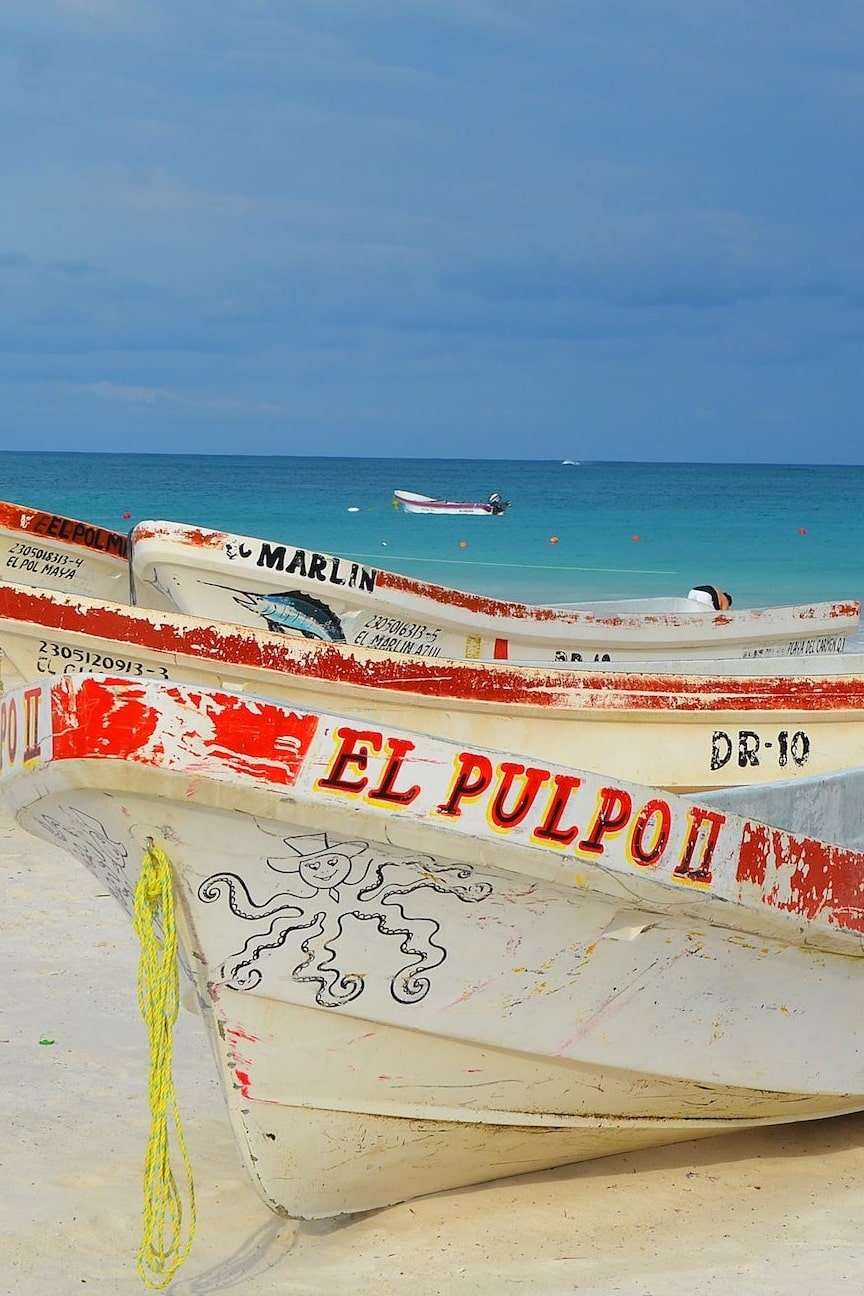 Planning Your Getaway: The Best Guide to Traveling in Playa del Carmen 4 Boats on beach in Mexico resized min