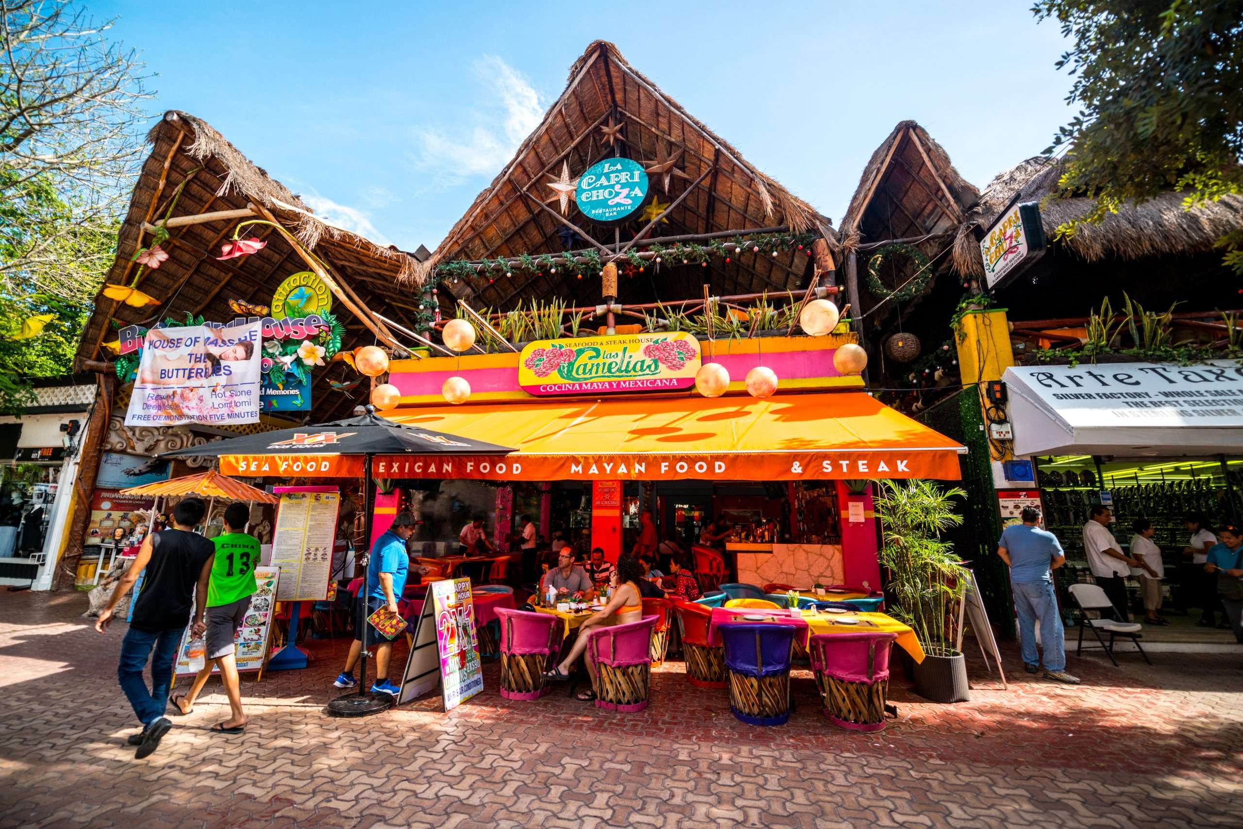Planning Your Getaway: The Best Guide to Traveling in Playa del Carmen 3 Tourists exploring famous shopping street in Playa Del Carmen - 5th Avenue