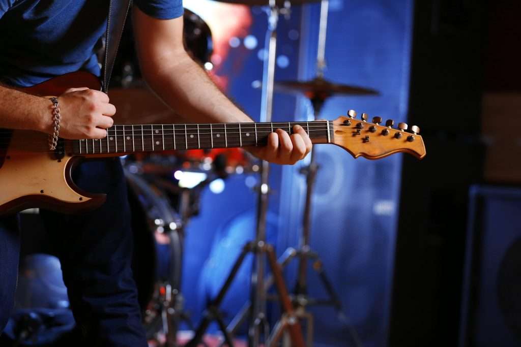 Twilight Treasures: Playa del Carmen’s Nightlife and Entertainment Hotspots 3 Man playing electric guitar close up