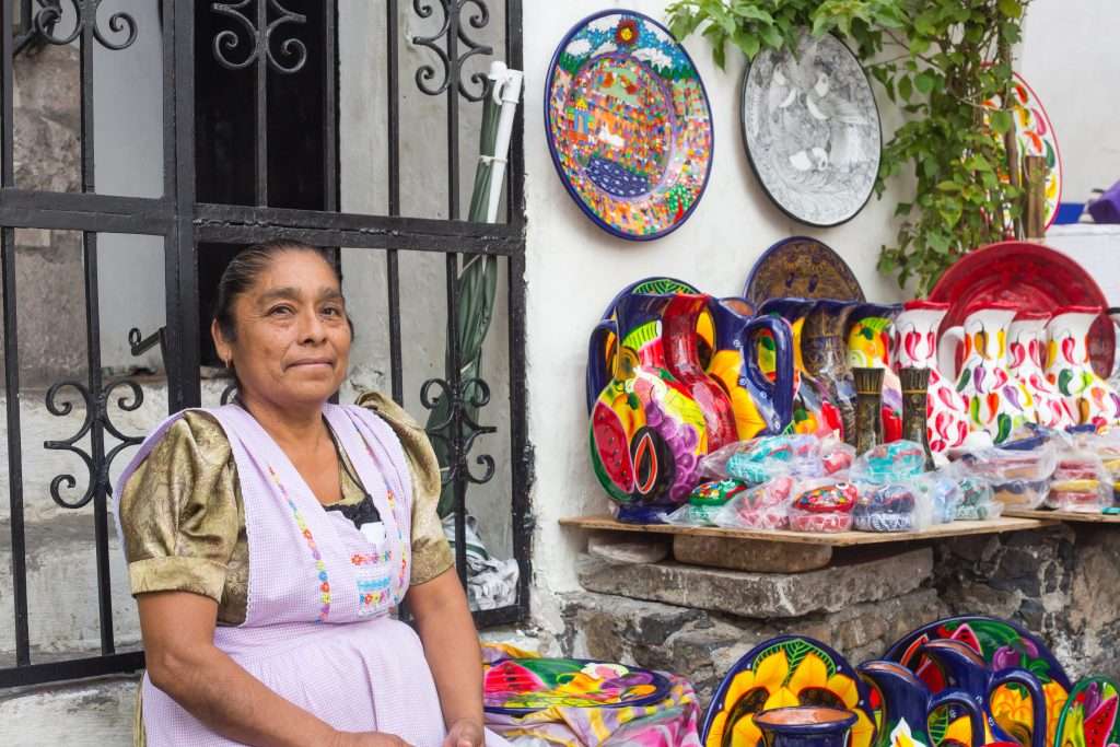 Beyond 5th Avenue: Hidden Shopping Spots in Playa del Carmen 1 Mexican colorful pottery vendor